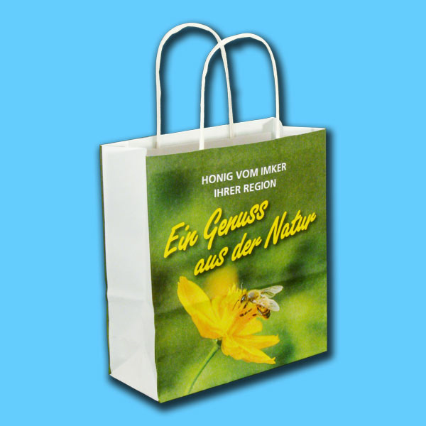 Diese Papiertragetasche mit Kordelgriff ist ideal für die Präsentation von Honiggläsern. Sie trägt den Aufdruck Ein Genuss aus der Natur - Honig vom Imker Ihrer Region und ist eine elegante Verpackungslösung für Imker*innen.
