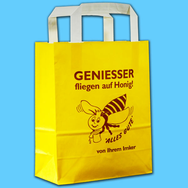 Die Papier-Tragetasche Geniesser in leuchtendem Gelb ist ein praktisches Accessoire für Imker*innen. Sie bietet Platz für zwei bis vier Honiggläser und sorgt für einen sicheren Transport. Der weiße Henkel rundet das Design ab und ermöglicht ein bequemes Tragen. Die Tasche ist eine ideale Lösung für Märkte oder beim Direktverkauf.