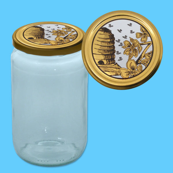 Das runde Honigglas mit 1000 g und einem TO-Deckel, auf dem ein gold-weißes Design mit Bienenkorb und Blumen dargestellt ist, bietet eine besonders elegante Verpackung. Ideal für Imker, die ihre Produkte mit einer ansprechenden und edlen Optik präsentieren möchten.